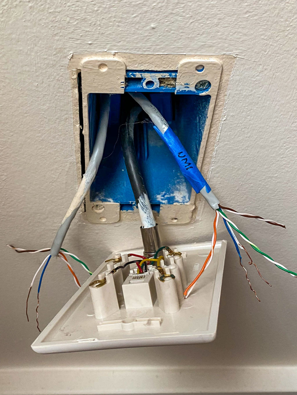 RJ14 phone jack with Cat 5e cables behind it